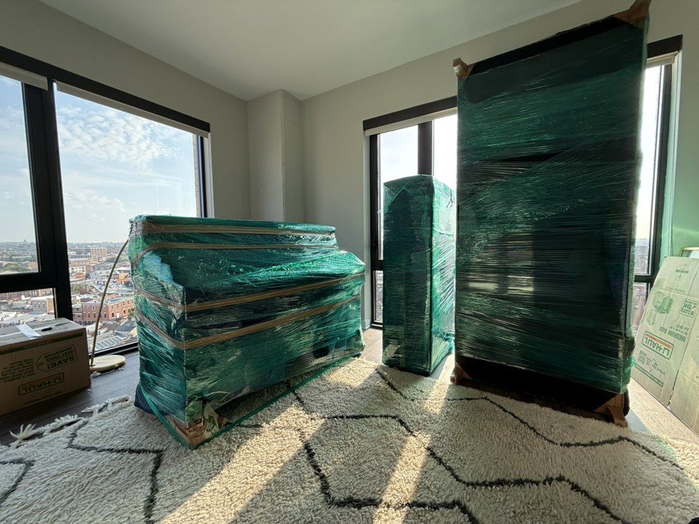 Wrapped dresser, mirror and headboard staged in a high-rise