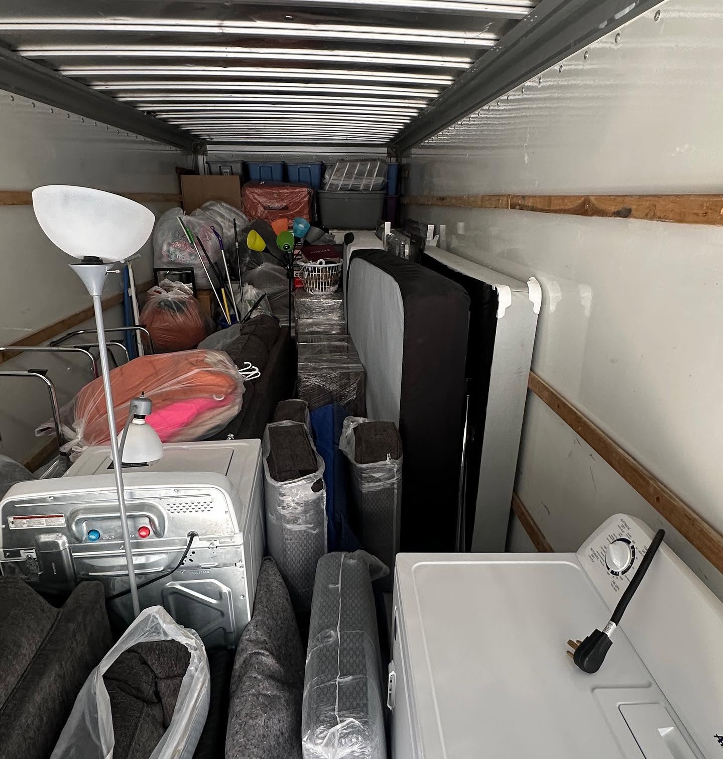 Wayne's Enterprise truck packed wall to wall with wrapped furniture, mattresses and appliances