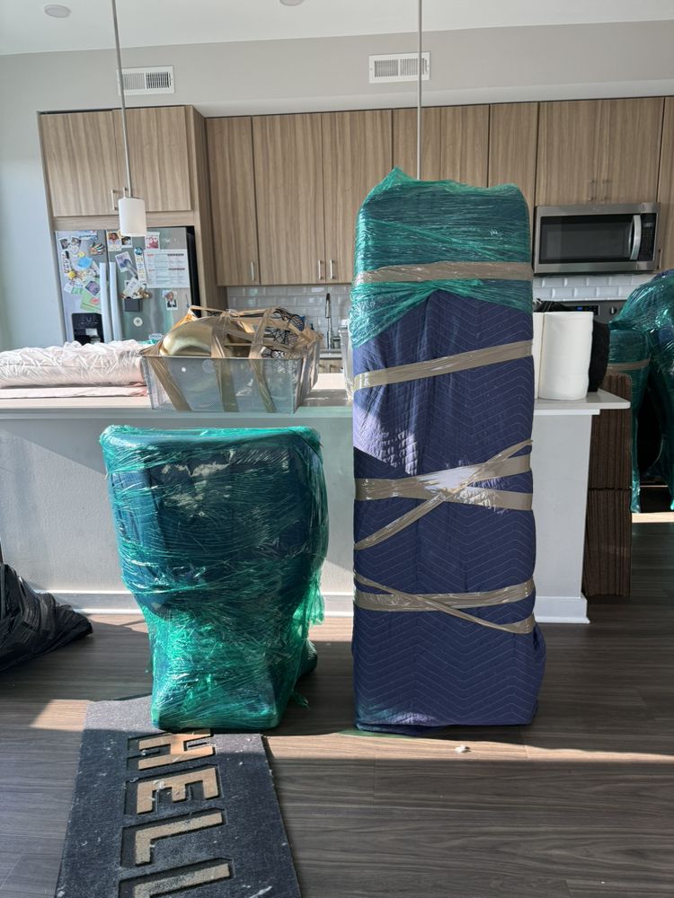 Wrapped armchair and rolled rug in a kitchen